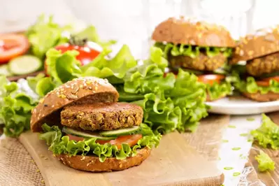 lentil burger served on a whole grain bun topped with lettuce, pickles, and lettuce