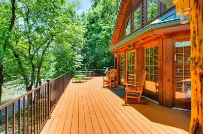 a river adventure cabin in pigeon forge with a river out front