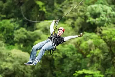 A man going ziplining.