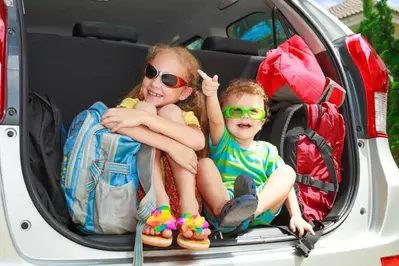 Siblings in the car on a vacation road trip.