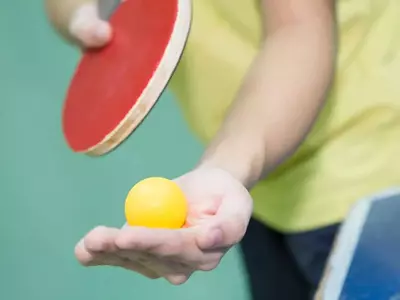 Boy playing ping pong in a Gatlinburg cabin with a game room