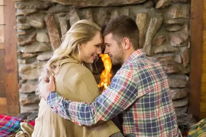 Happy couple in front of a romantic one bedroom Gatlinburg cabin