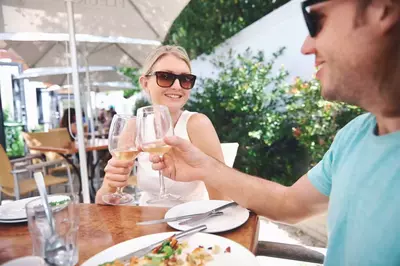 Couple drinking white wine at lunch while on summer vacation